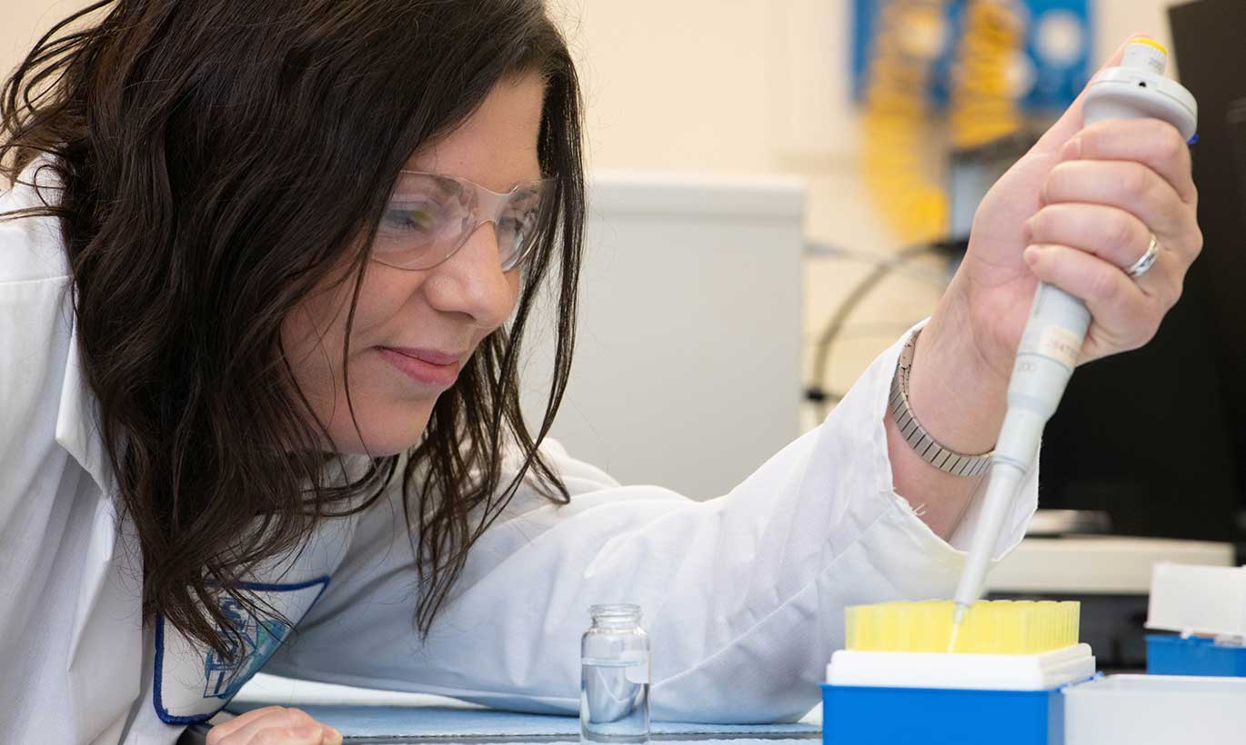 A woman at the Southwest Research Institute fills test tubes in San Antonio, Texas