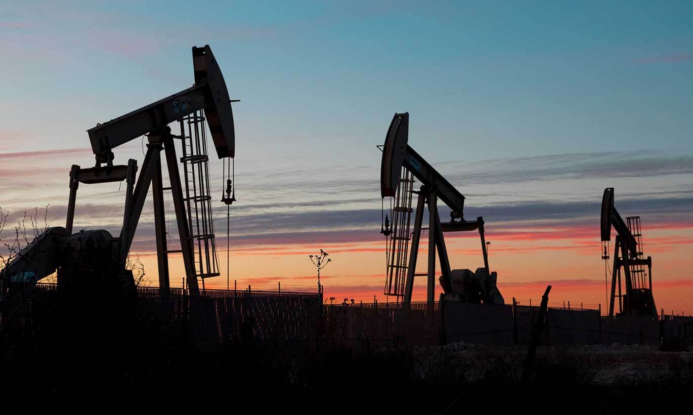 Silhouettes of oil rigs during sunset in Texas