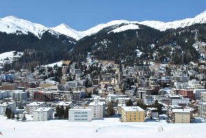 Snow capped mountains in the background with the city of Davos, Switzerland in the foreground