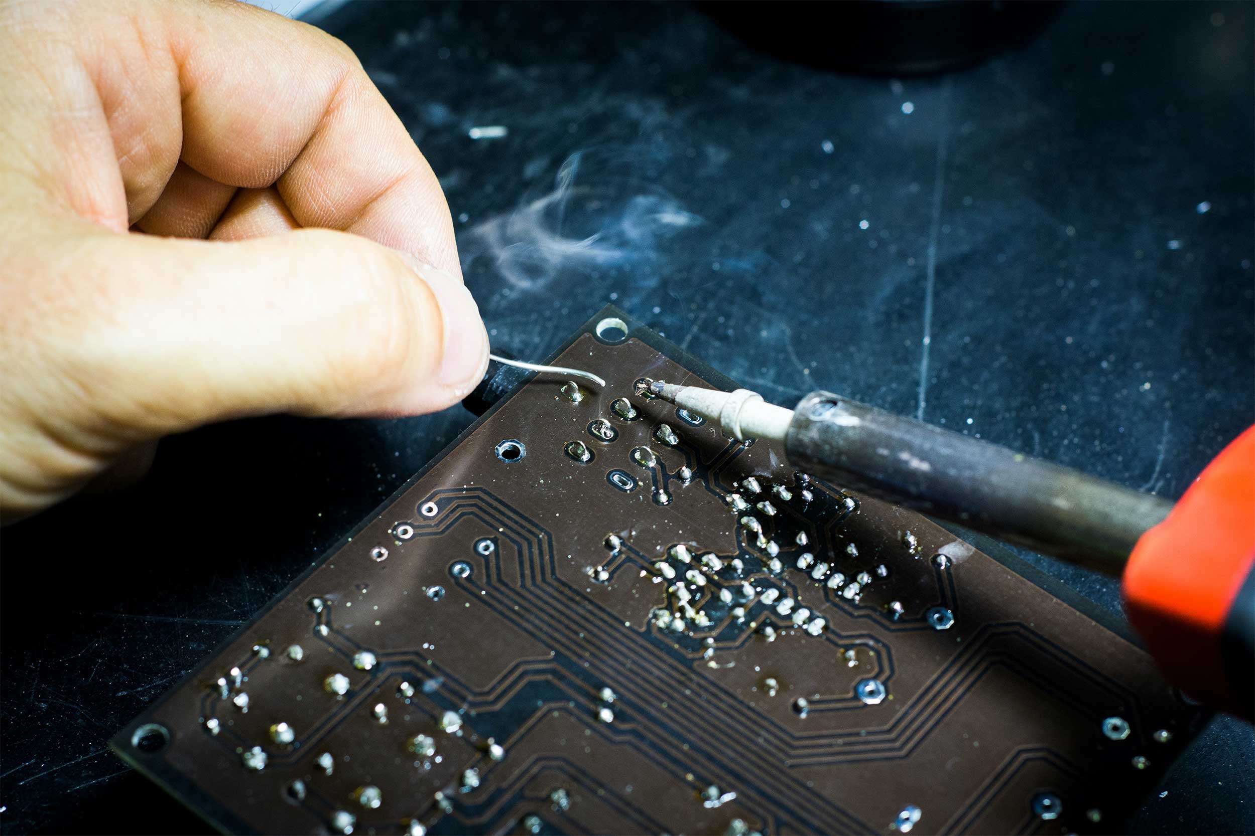 A technician fixing a computer microchip