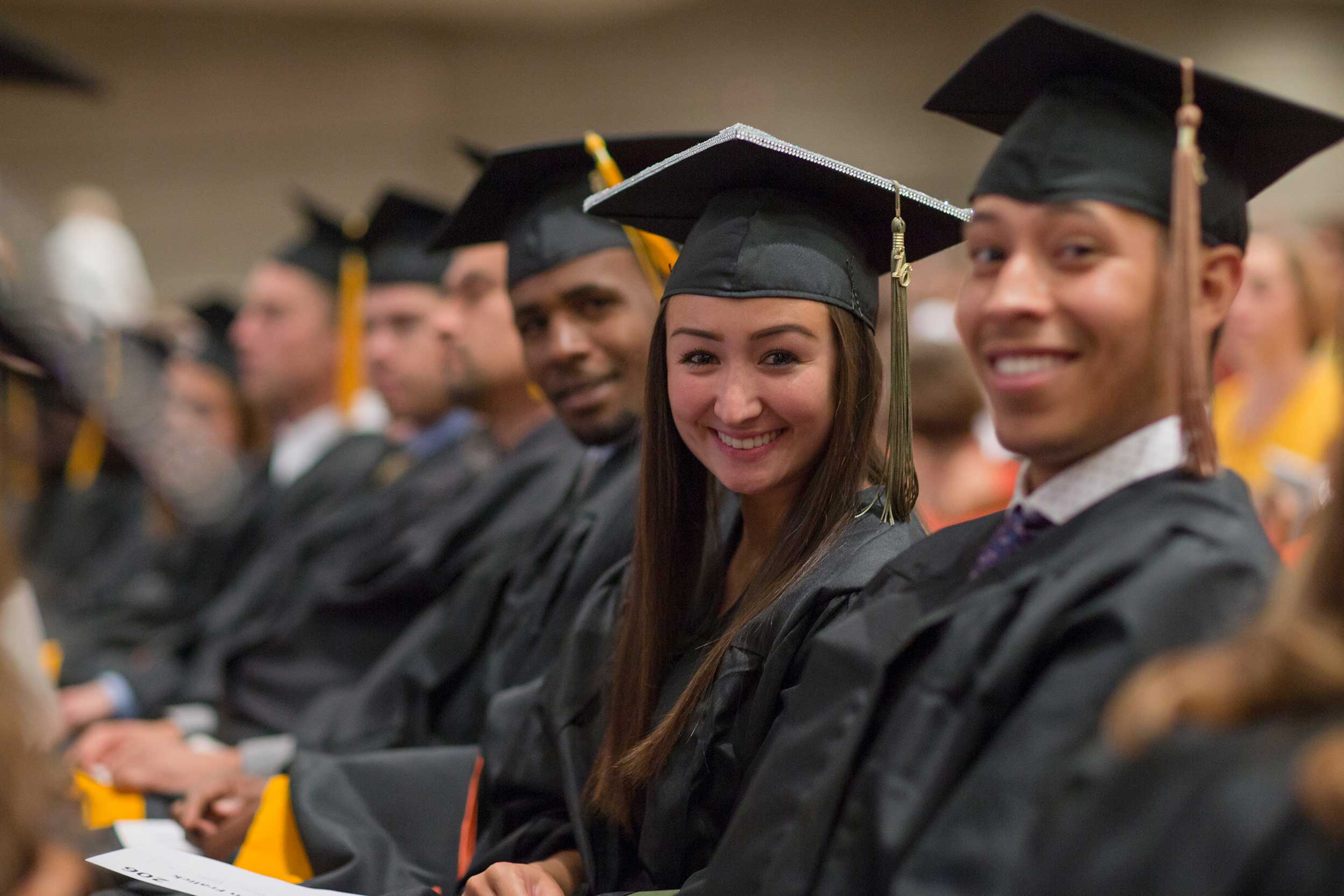 A group of students smile at graduation in Odessa, Texas.