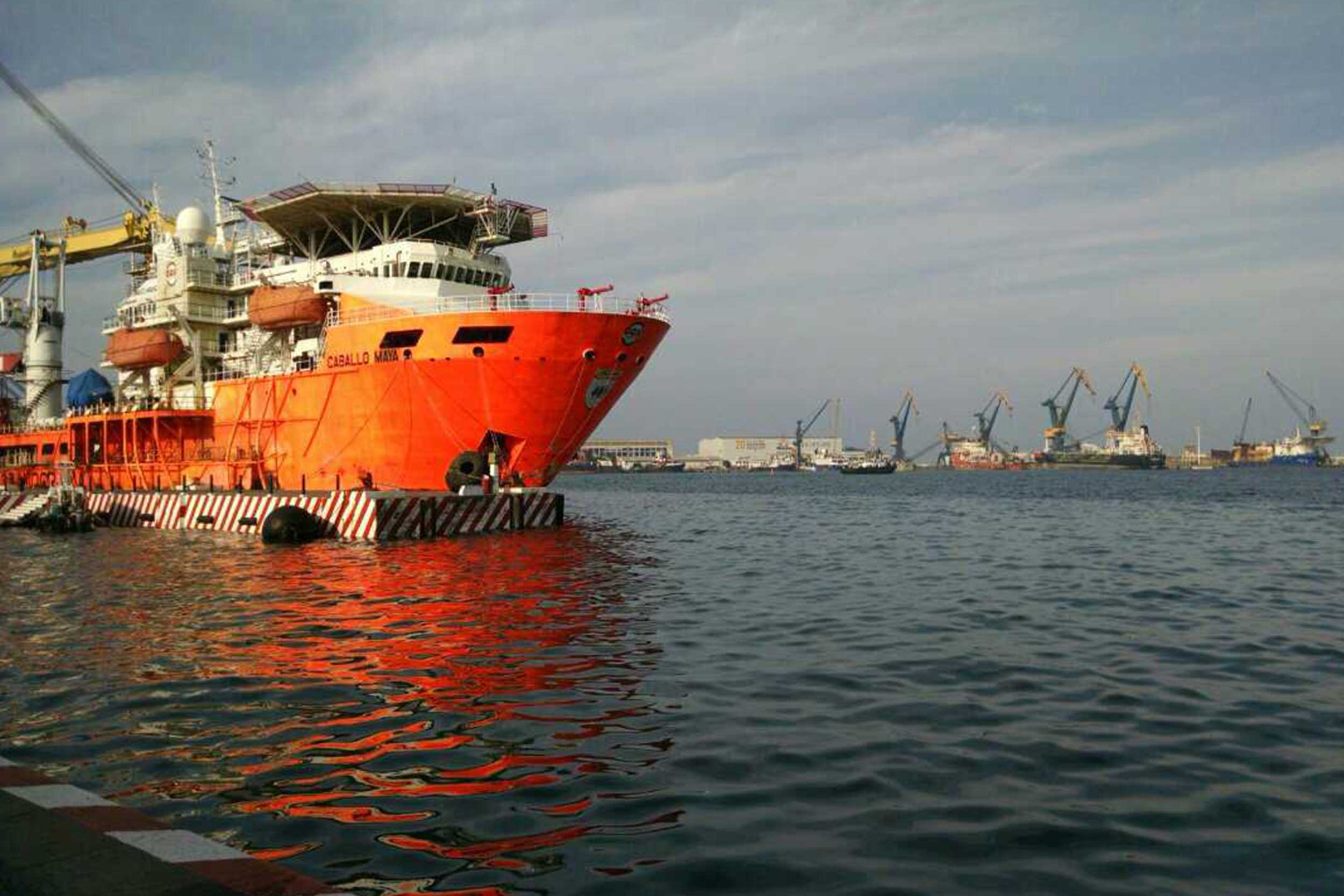 A large cargo ship moves through the ocean