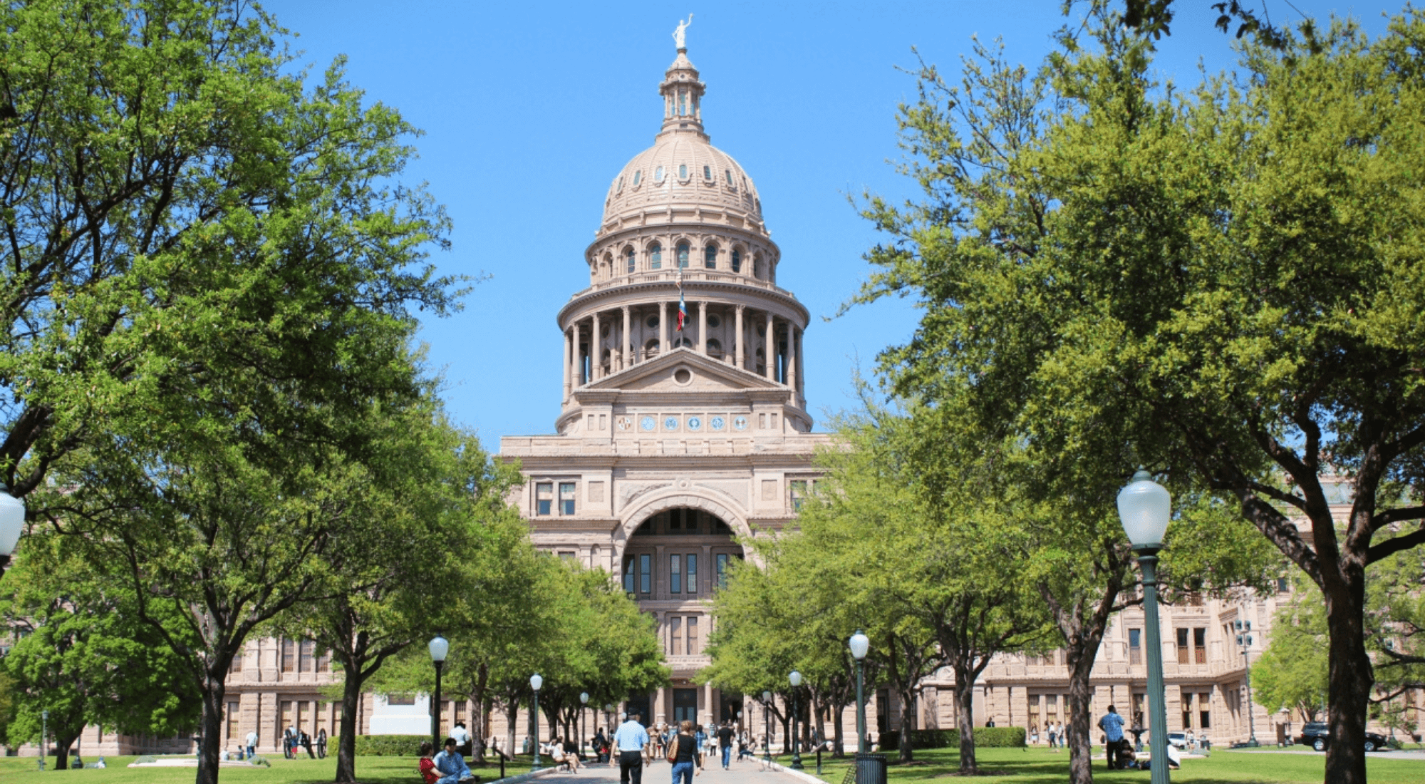 Austin, Texas Capital Building view from path with trees lined on left and right