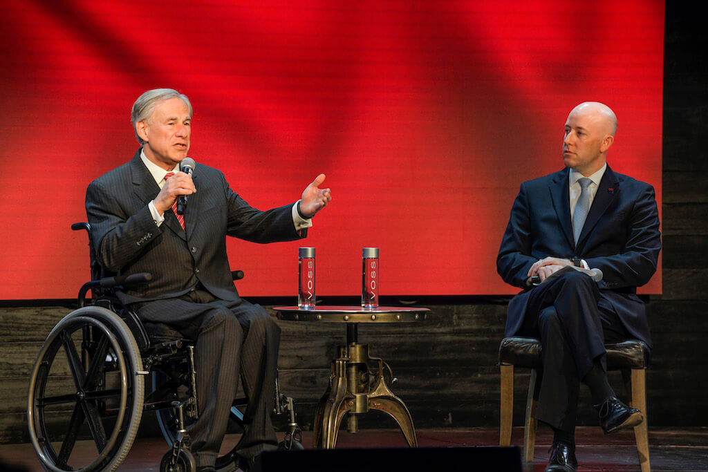 Governor Abbott and TxEDC CEO Robert Allen talking at a Fireside Chat for TxEDC investors