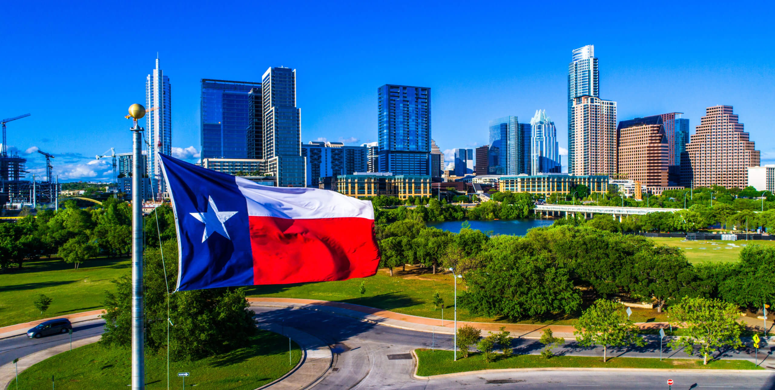 Colorful Austin, Texas Skyline with Texas Flag waving in the foreground