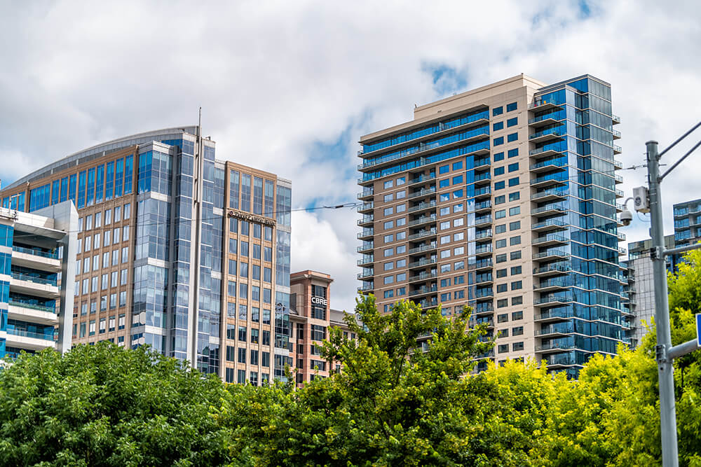 Downtown cityscape buildings in Dallas, Texas with signs for Texas Capital Bank and CBRE