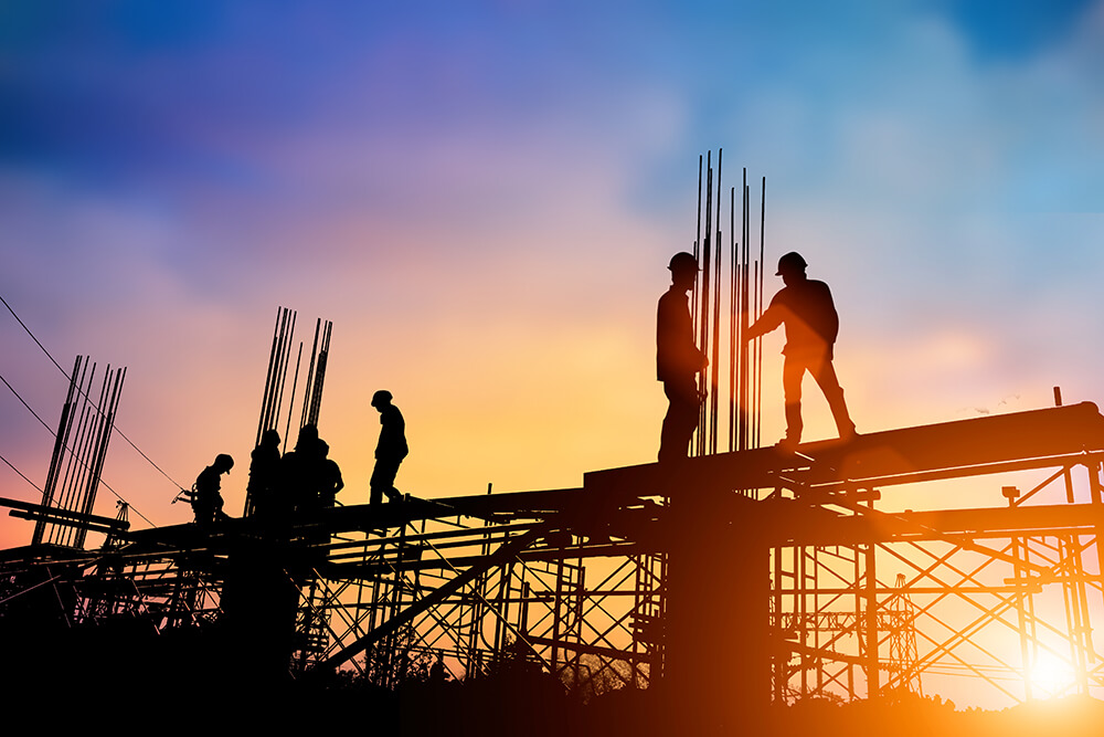 Silhouette engineer standing orders for construction crews to work on high ground