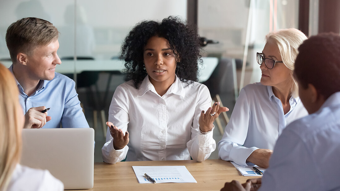 Professionals discussing business around a table