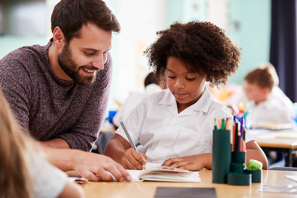 Male teacher with elementary school student